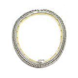 The Vibrant Necklace Set, a three-piece set with a gold cuban link chain, a silver paperclip chain, and a silver tennis chain with a padlock charm.