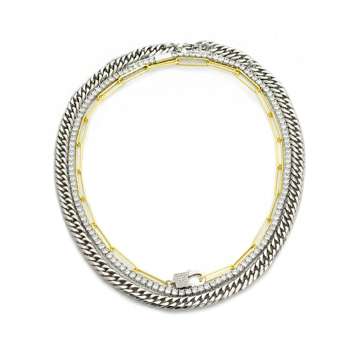 The Vibrant Necklace Set, a three-piece set with a gold cuban link chain, a silver paperclip chain, and a silver tennis chain with a padlock charm.