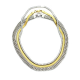 The Exciting Necklace Set, a 3 piece layered necklace with chains in gold and silver tones. It includes the Tennis Necklace, Gold snake necklace and the Silver Marinero chain necklace.