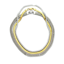 The Exciting Necklace Set, a 3 piece layered necklace with chains in gold and silver tones. It includes the Tennis Necklace, Gold snake necklace and the Silver Marinero chain necklace.