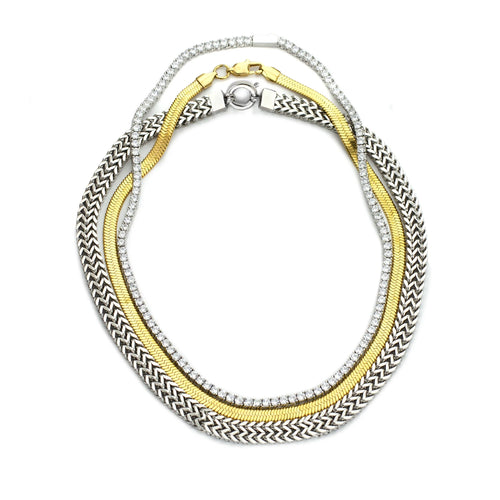 The Exciting Necklace Set, a 3 piece layered necklace with chains in gold and silver tones. It includes the Tennis Necklace, Gold snake necklace and the Silver Marinero chain necklace.