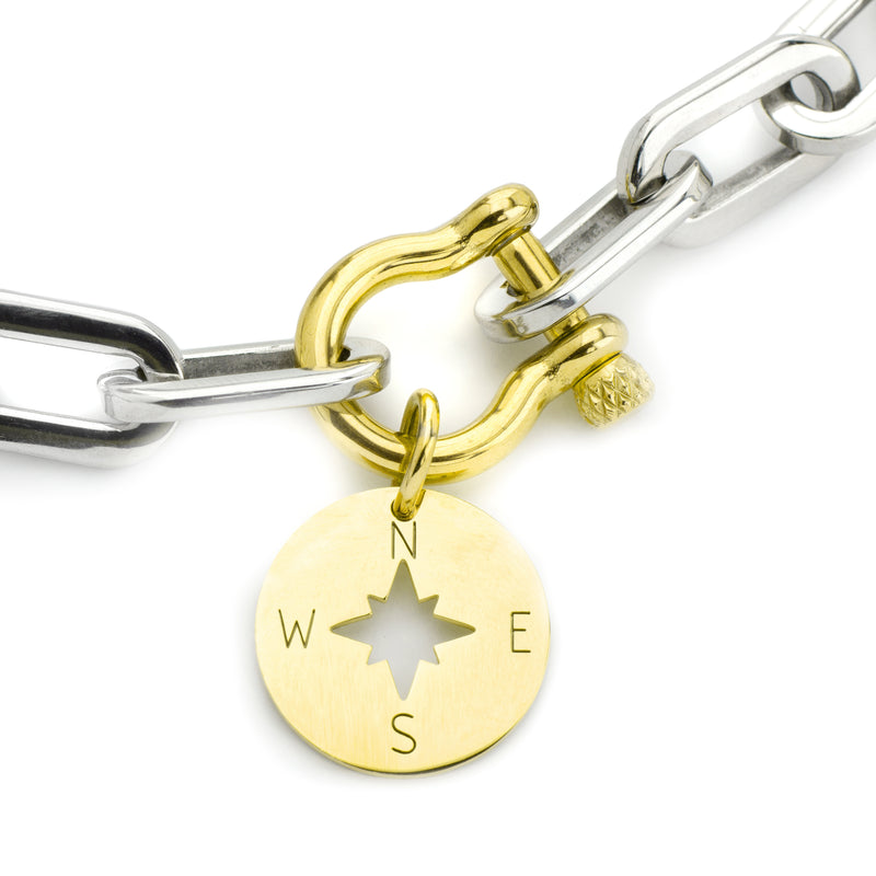 silver chains with an 18k gold plated stainless steel horseshoe lock and a gold compass charm of the Herradura Puerto.