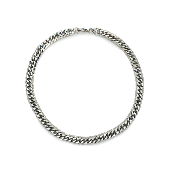 The Small Tropicana Silver, which is a single silver chain necklace featuring a bold and modern curb link design, perfect for adding a touch of sophistication and versatility to any outfit.