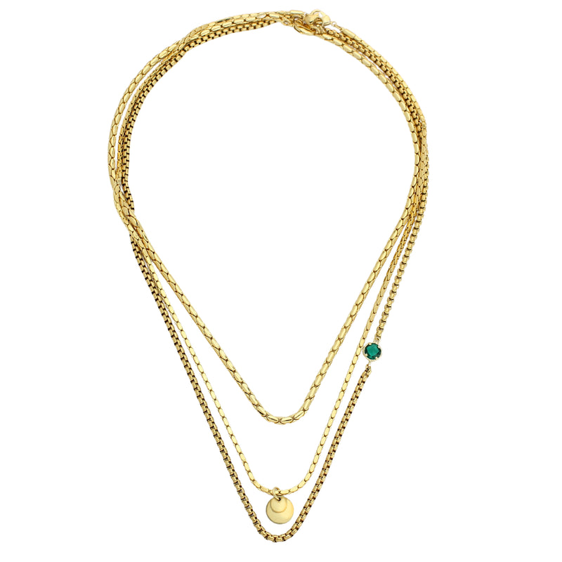 The EMERALD SNAKE NECKLACE SET which includes three layered chains all made of 18k gold plated brass chains with Raw brass coin pendant and a Man-made 18k gold plated emerald pendant disc. The lengths of the necklaces are 17", 19"and 20".  