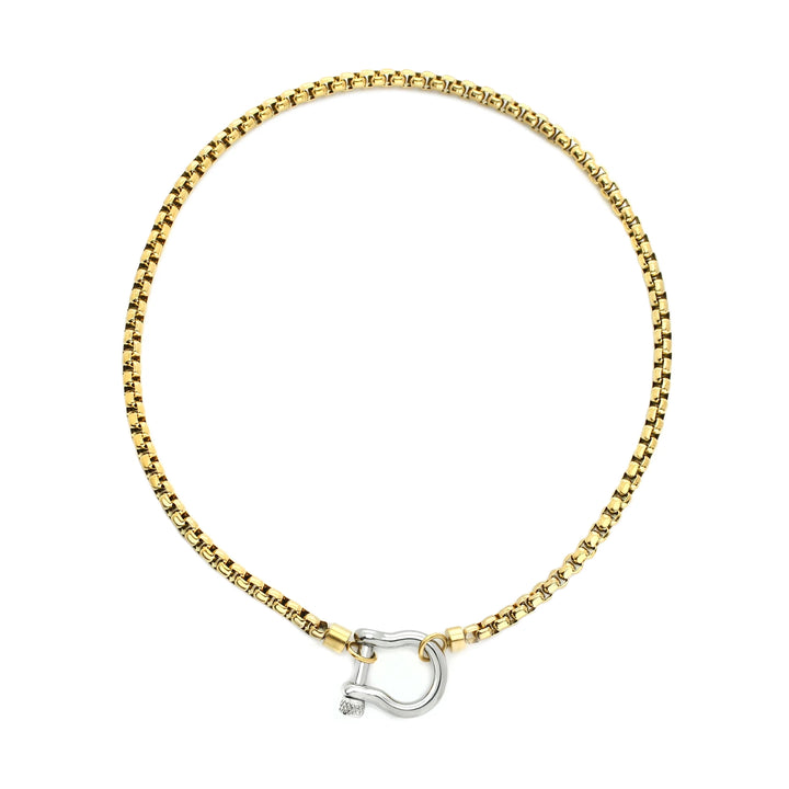 The Herradura Mix Necklace, a gold necklace featuring a box chain with a silver horseshoe clasp. |||Silver