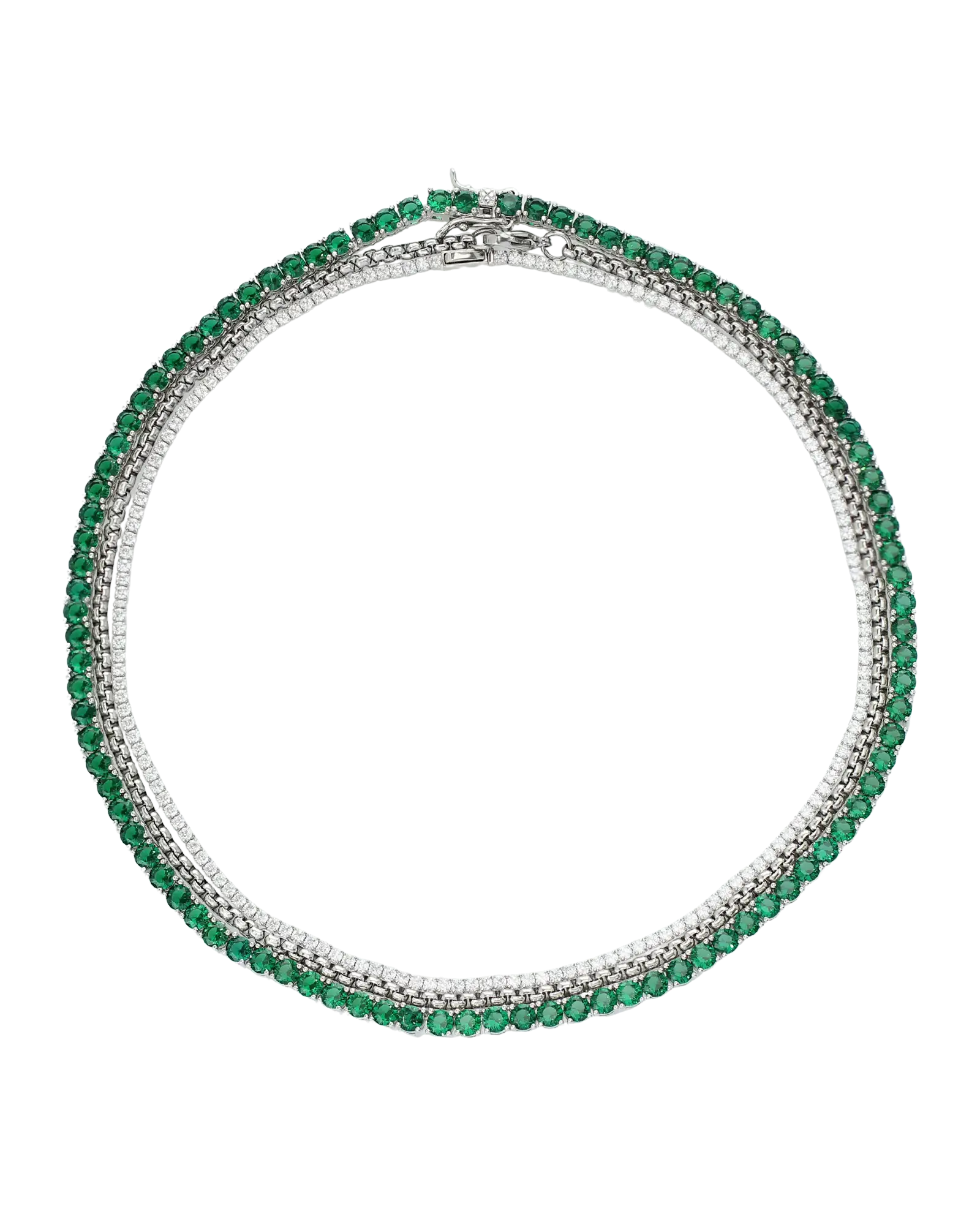 The Emerald Tennis Necklace Set, a three-piece silver necklace set featuring a single strand of emerald green gemstones, a single strand of white cubic zirconia, and a three-row necklace with alternating emerald green gemstones and white cubic zirconia.