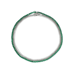 The Emerald Tennis Necklace Set, a three-piece silver necklace set featuring a single strand of emerald green gemstones, a single strand of white cubic zirconia, and a three-row necklace with alternating emerald green gemstones and white cubic zirconia.