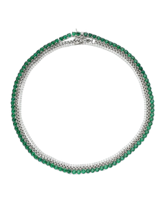The Emerald Tennis Necklace Set, a three-piece silver necklace set featuring a single strand of emerald green gemstones, a single strand of white cubic zirconia, and a three-row necklace with alternating emerald green gemstones and white cubic zirconia.