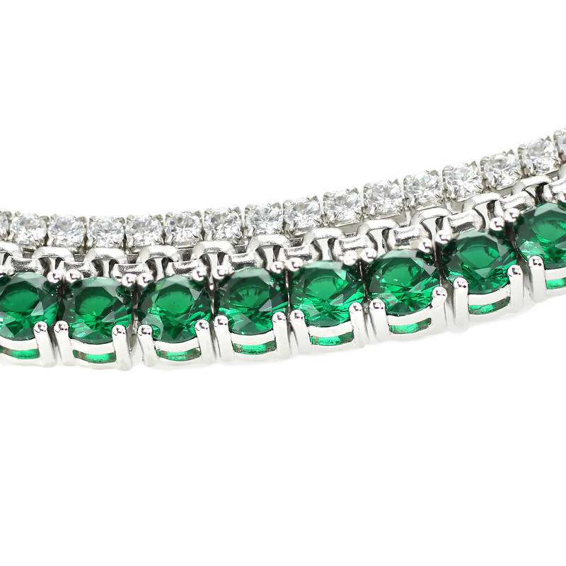 The EMERALD TENNIS NECKLACE SET which includes 3 layered necklaces. A Stainless steel Rhodium plated chain that is 1mm Wide, a 925 sterling silver cubic zirconia tennis necklace - 2 mm wide and Man made emerald rhodium-plated brass/cubic zirconia.