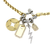 The Herradura Mix Necklace with 4 charms, the compass, plaque, lightning and the celestial charm, a gold charm with a  star design accented with pave diamonds.