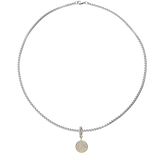 A silver necklace with the Circle Clip-On Charm, which is a two-toned charm featuring a circular gold pendant paved with sparkling diamonds and a silver clip embellished with a row of smaller diamonds.